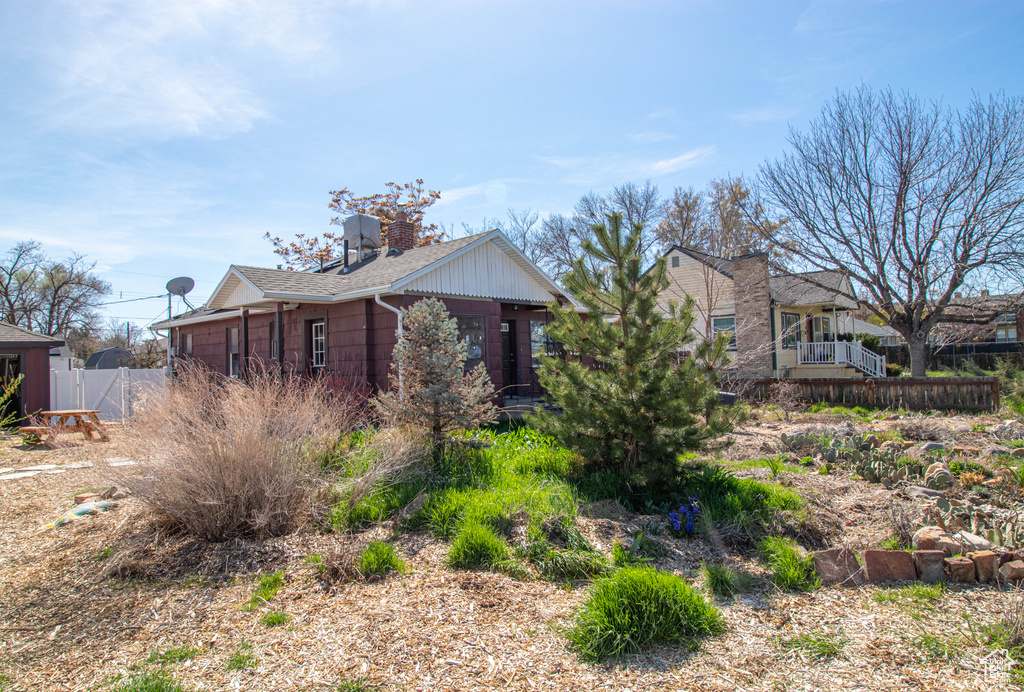 View of side of home featuring fence