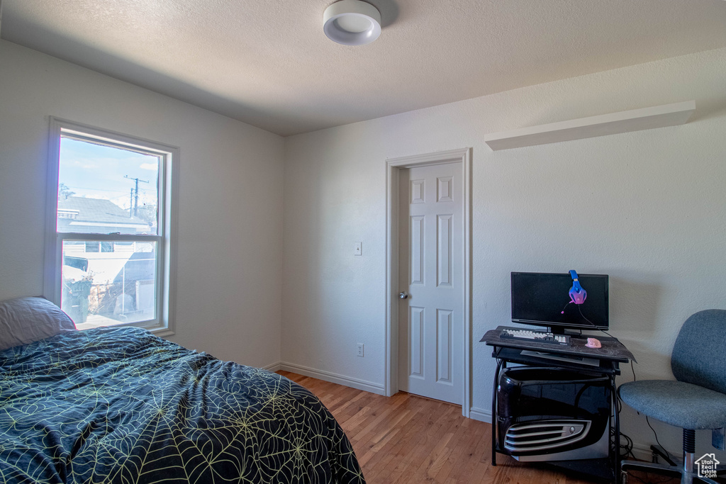 Bedroom featuring light wood-type flooring and baseboards
