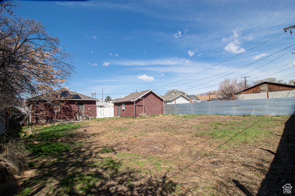 View of yard featuring fence and an outdoor structure
