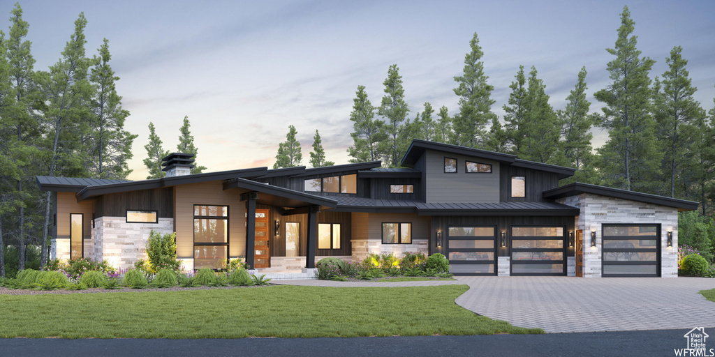 Contemporary house with stone siding, metal roof, and a standing seam roof