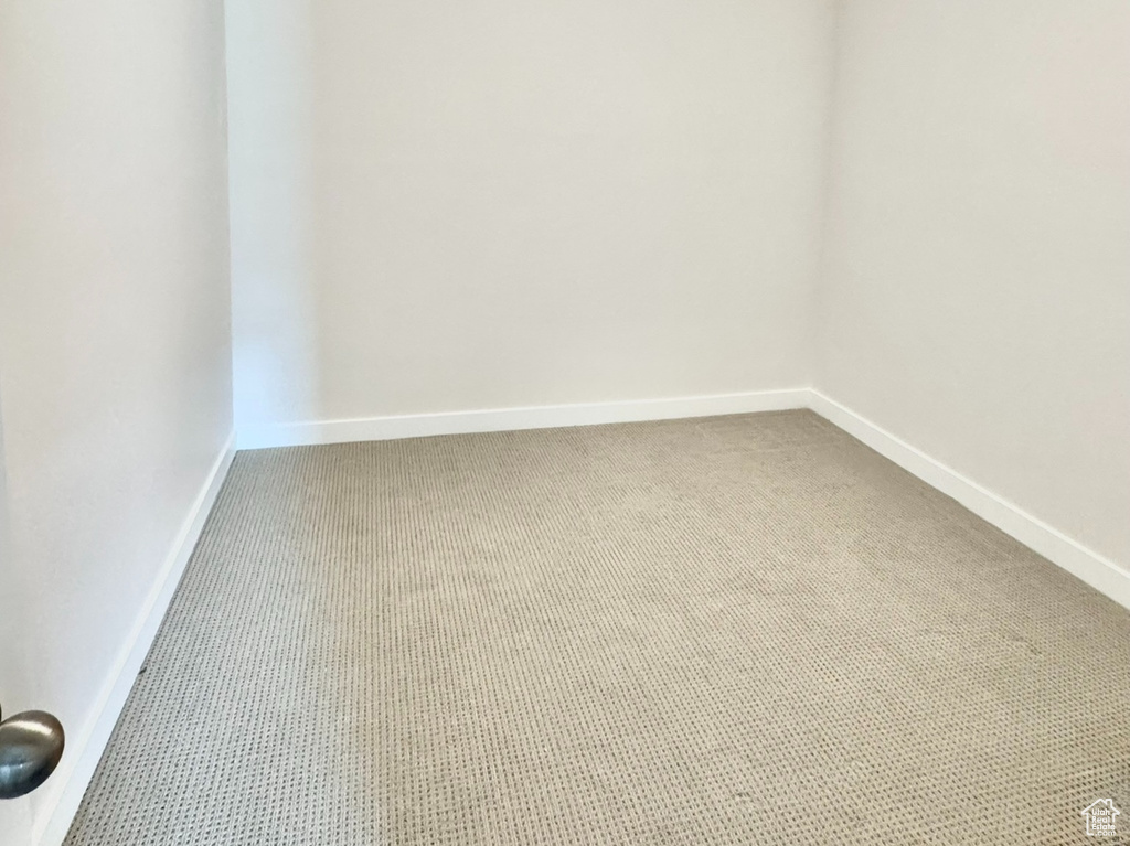 Carpeted spare room with baseboards