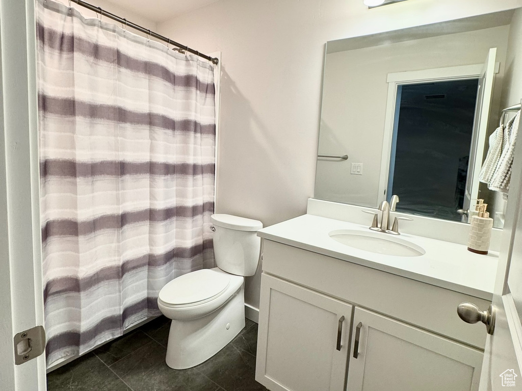 Full bathroom with toilet and vanity