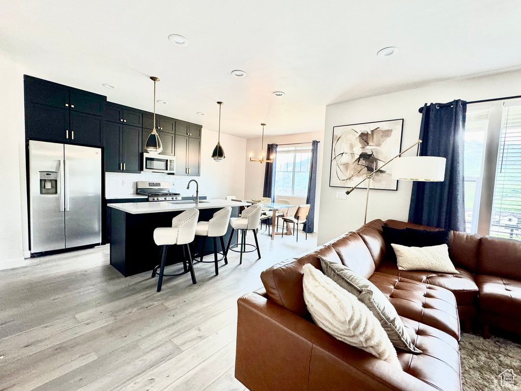 Living area featuring light wood-style flooring and recessed lighting