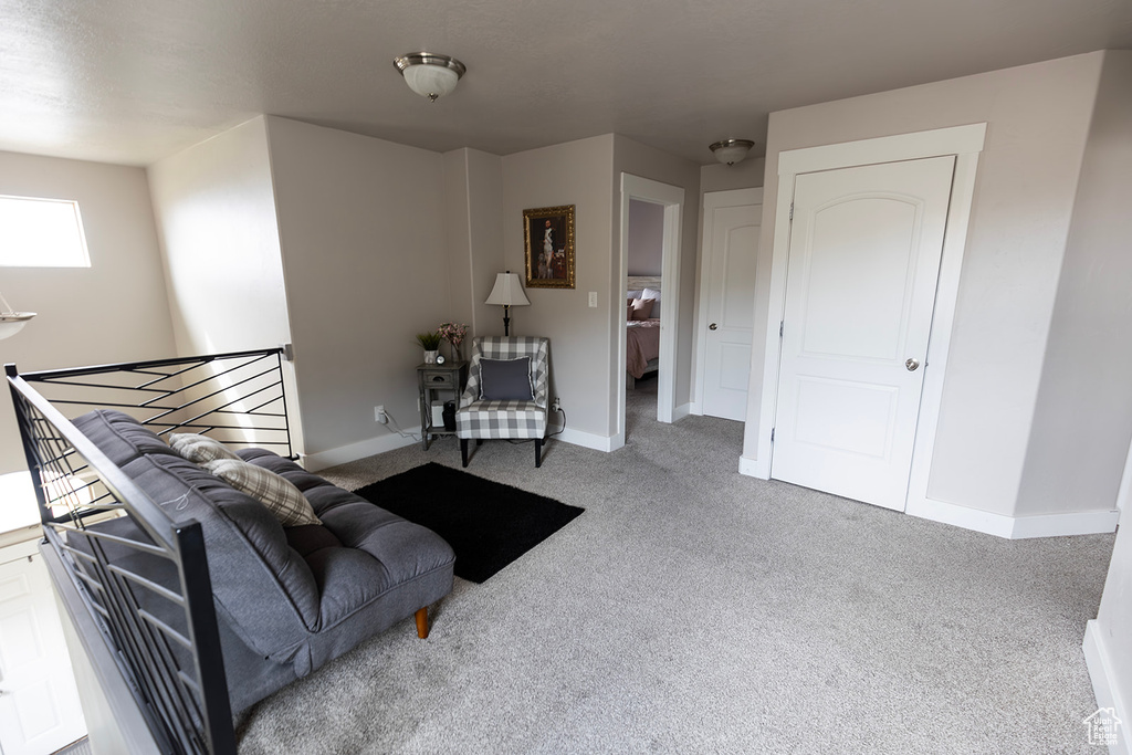 Living area with carpet flooring and baseboards
