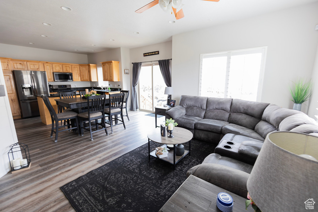Living area featuring light wood-style flooring, recessed lighting, and ceiling fan