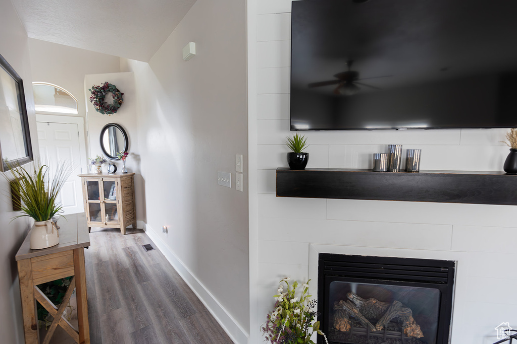 Hallway with baseboards and wood finished floors