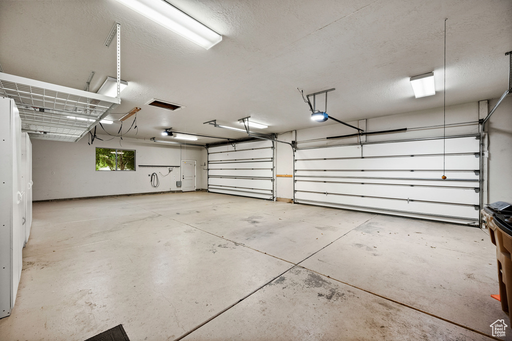 Garage featuring a garage door opener