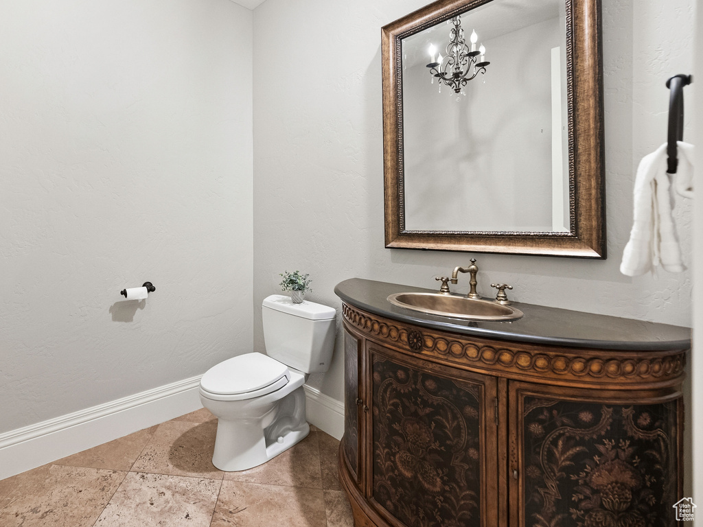 Half bath with a chandelier and vanity