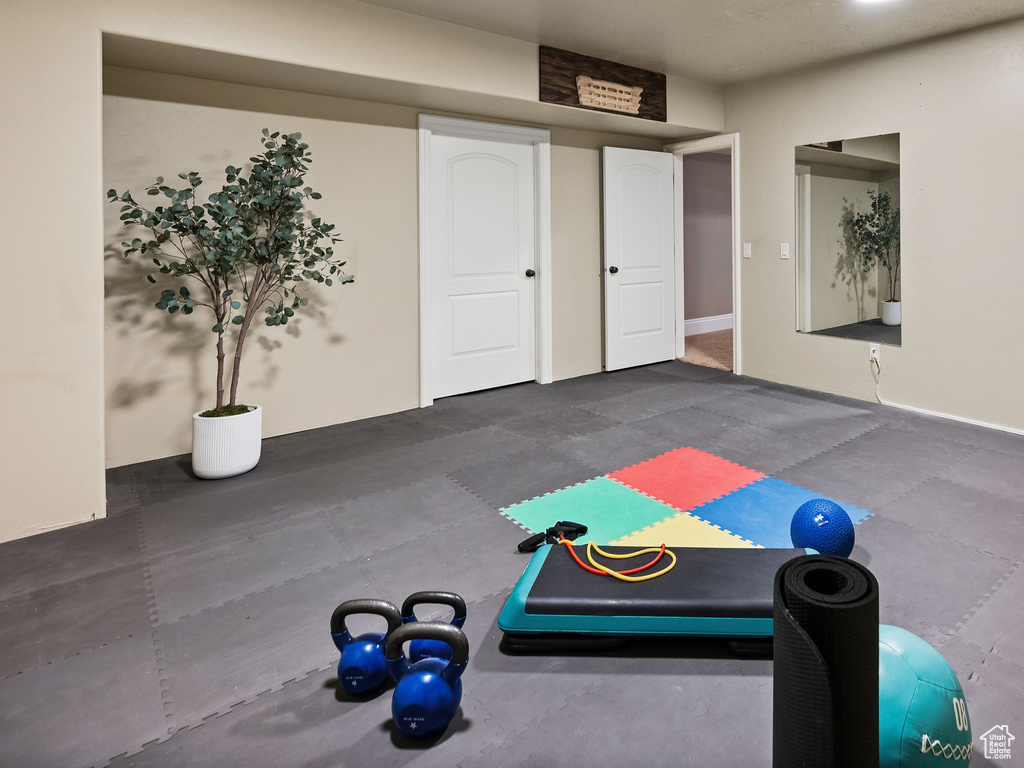 Workout room featuring recessed lighting