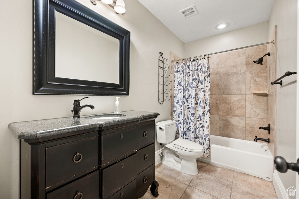 Full bath featuring vanity, shower / bath combination with curtain, and tile patterned flooring
