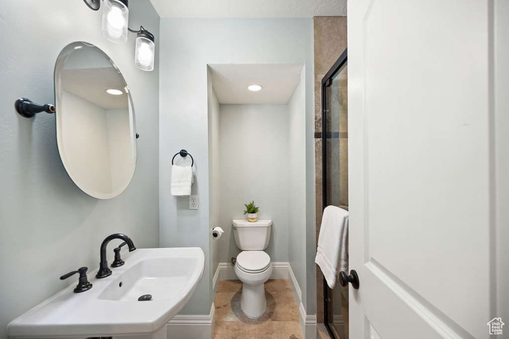 Full bathroom with a shower with shower door and tile patterned flooring