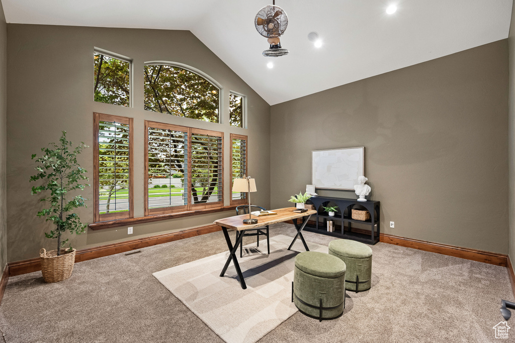 Office with carpet floors, high vaulted ceiling, plenty of natural light, and recessed lighting