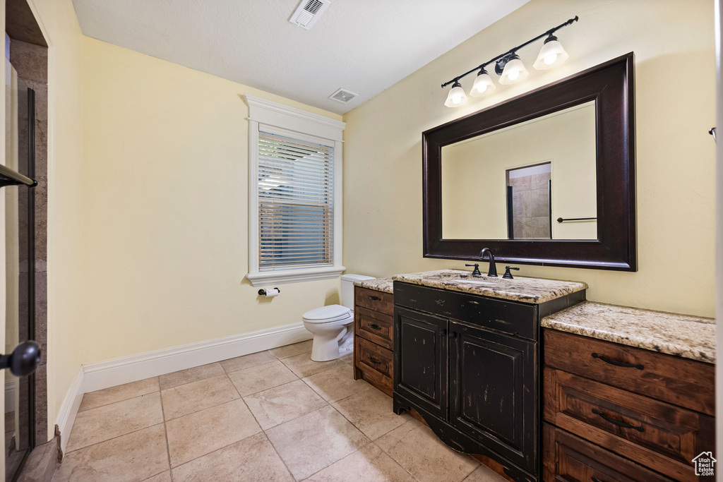 Bathroom featuring vanity and tile patterned floors