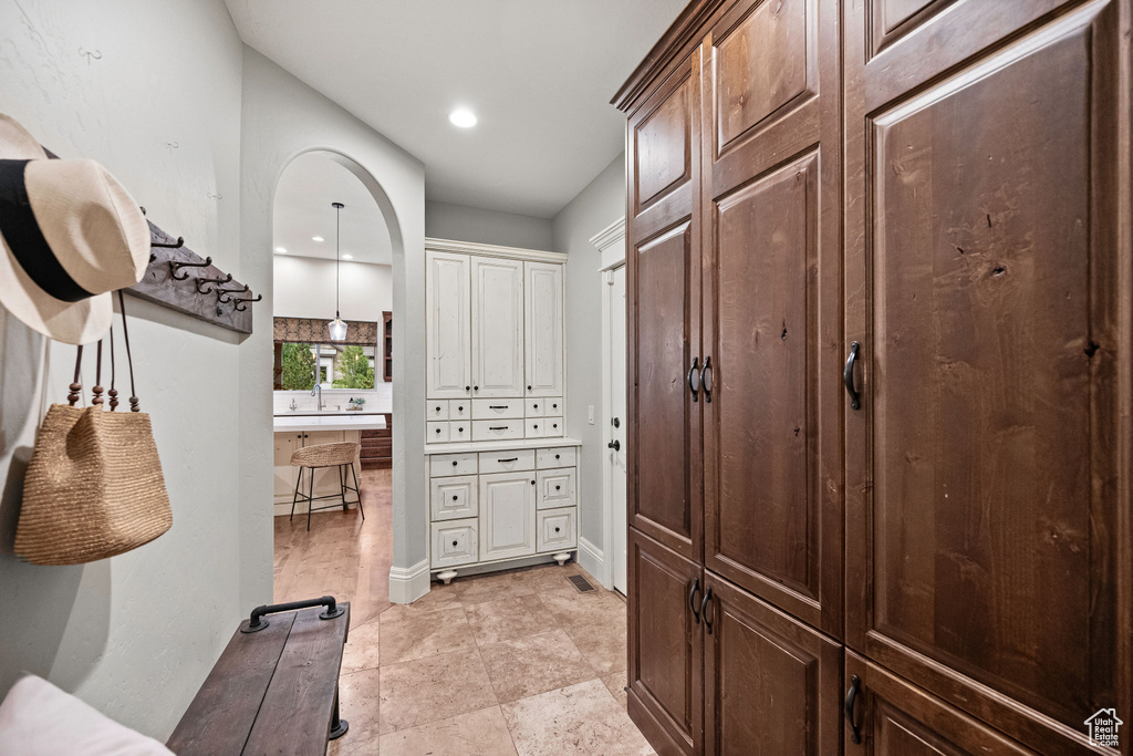 Hallway with recessed lighting and a sink