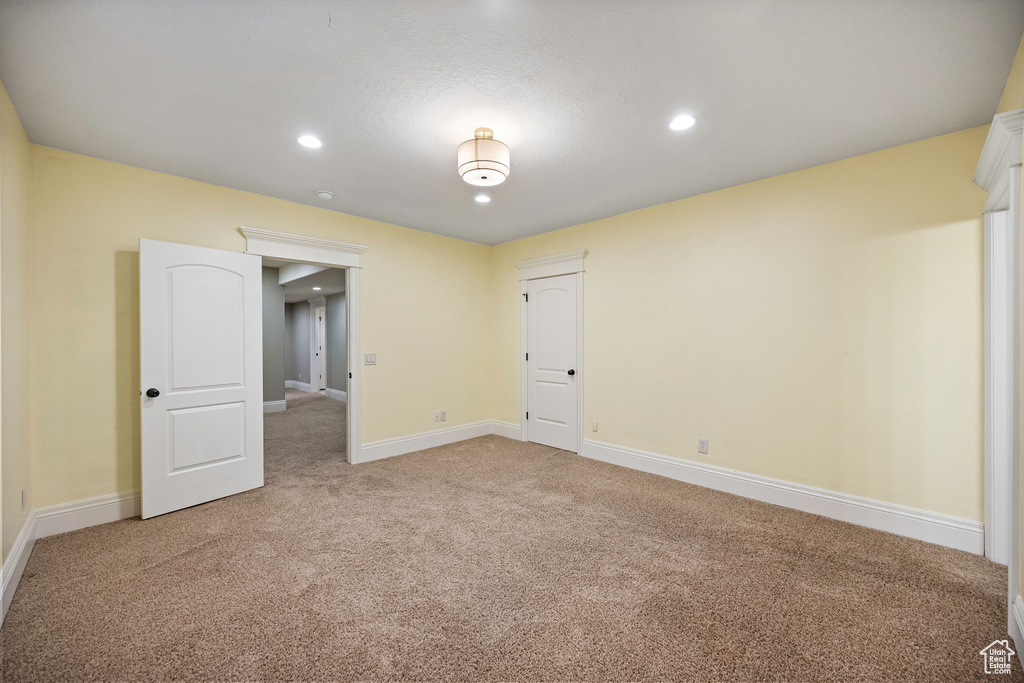 Spare room featuring light carpet and recessed lighting