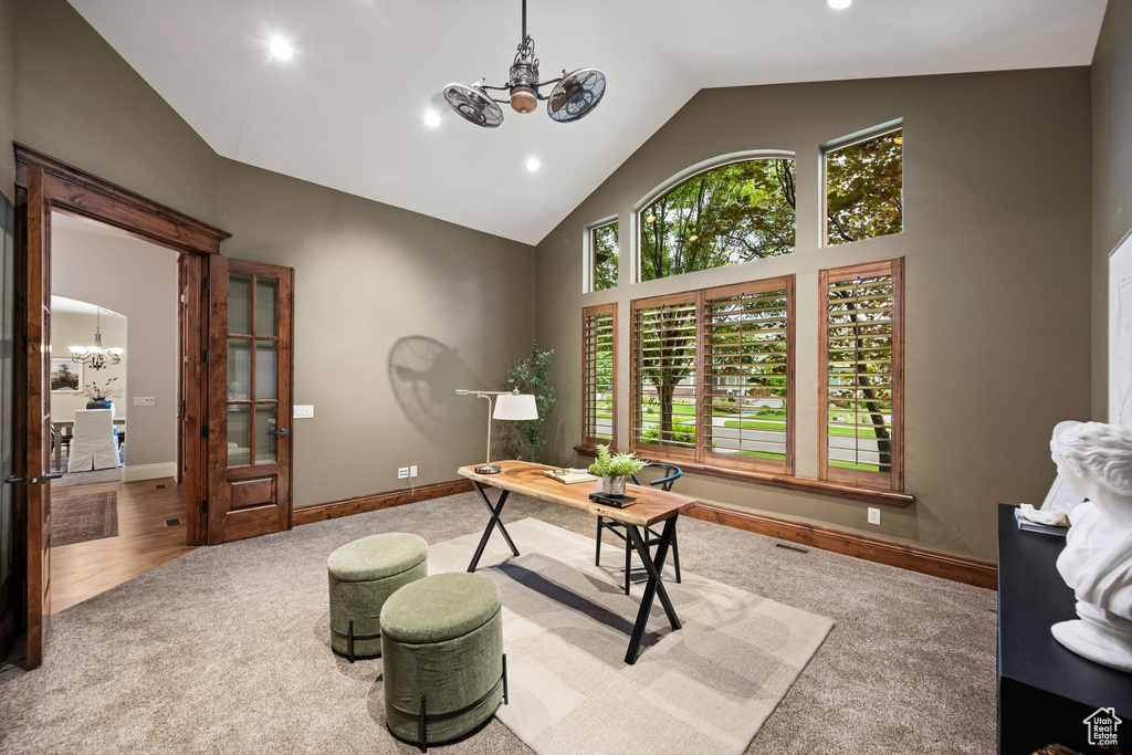 Office space featuring a chandelier, carpet, high vaulted ceiling, and recessed lighting