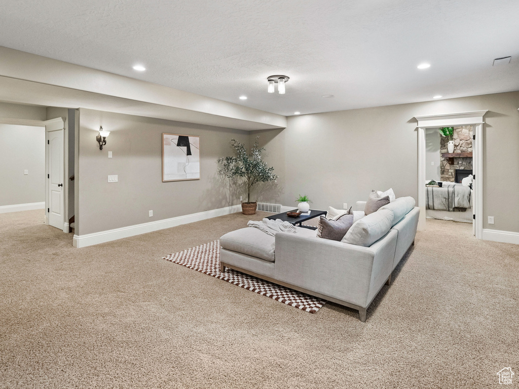 Living room with light colored carpet and recessed lighting