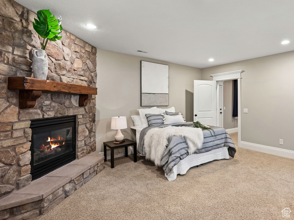 Bedroom featuring a fireplace, carpet, and recessed lighting