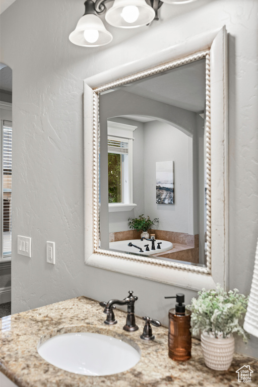 Bathroom with vanity and a textured wall
