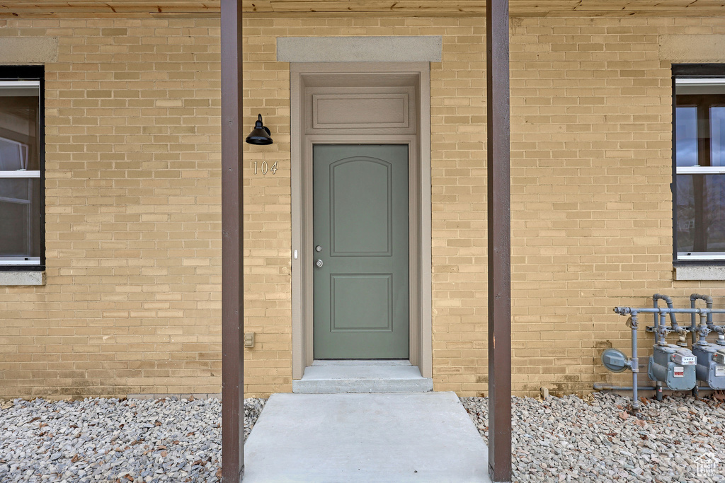 Property entrance featuring brick siding