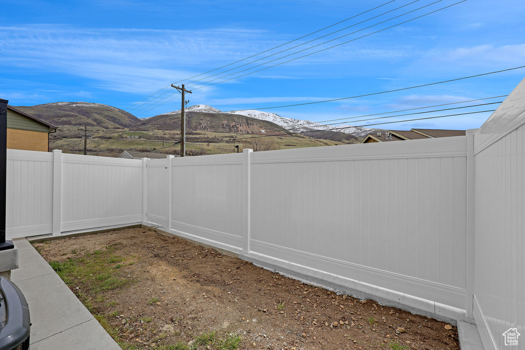 View of yard featuring a fenced backyard and a mountain view