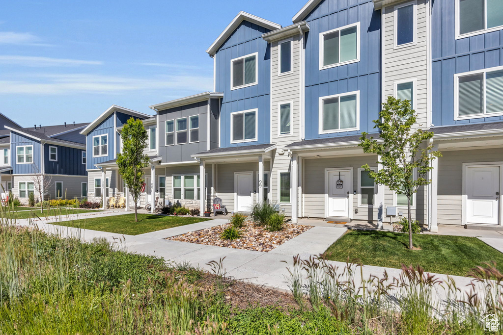 Townhome / multi-family property featuring a residential view and board and batten siding