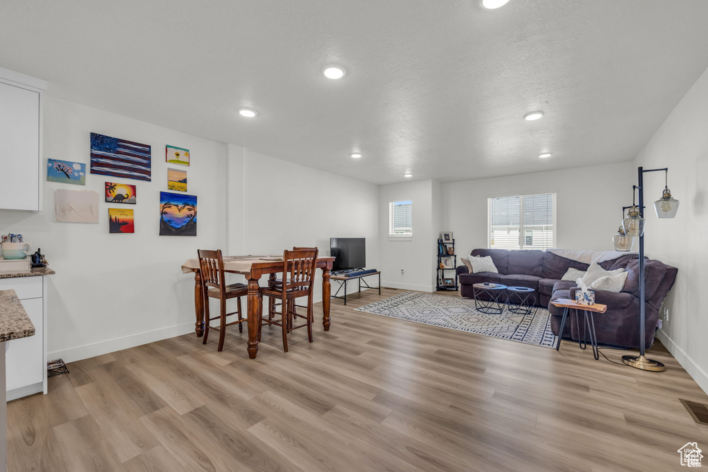 Dining room with recessed lighting, light wood-style floors, and baseboards
