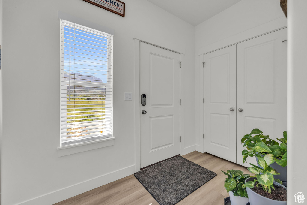 Entrance foyer featuring light wood-style flooring and baseboards