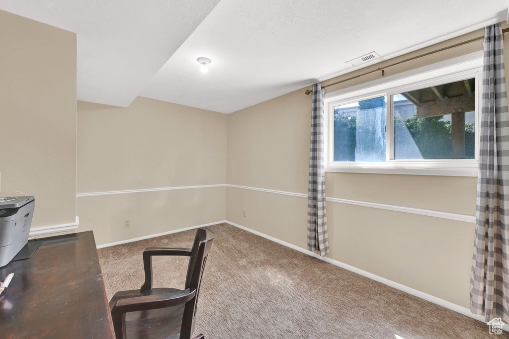 Unfurnished office featuring carpet floors, baseboards, and visible vents