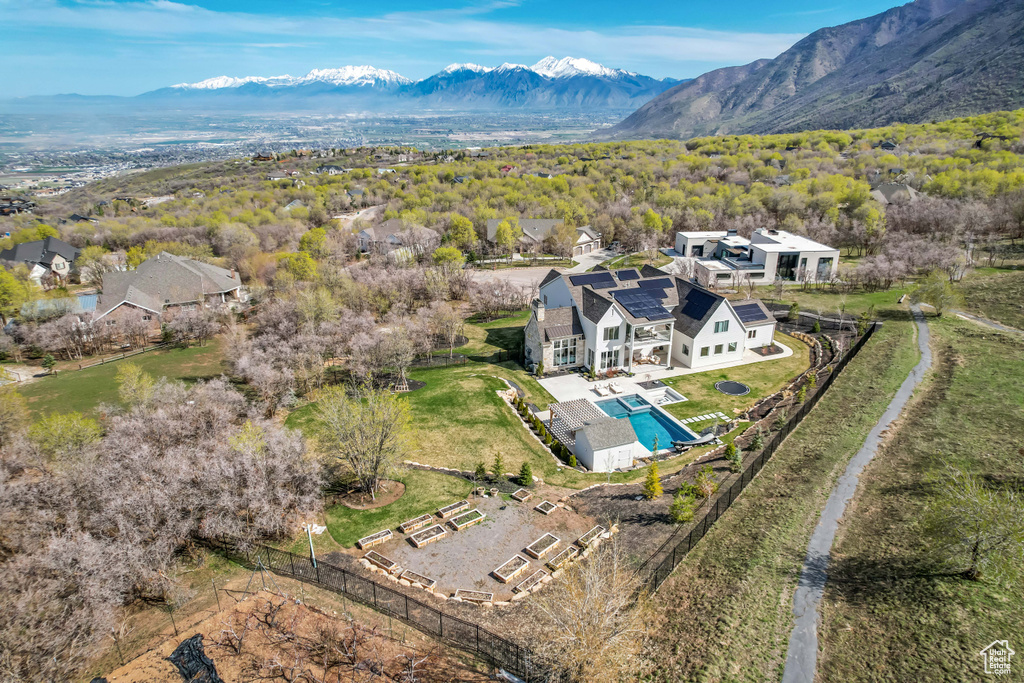 View of subject property with a mountainous background and a pool