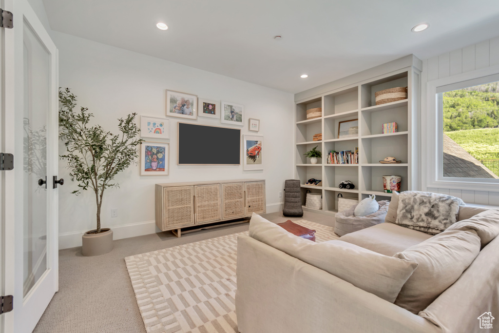 Living area with carpet, recessed lighting, and baseboards