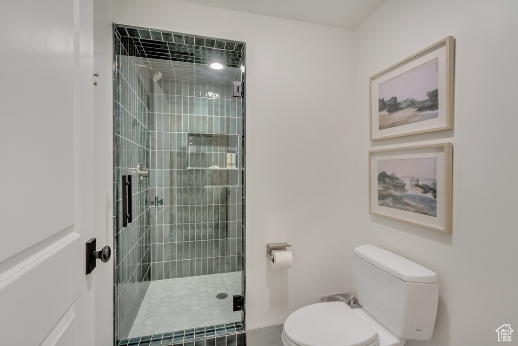 Full bathroom featuring toilet and a stall shower