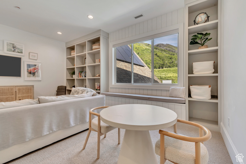 Living area with built in features, carpet, recessed lighting, and baseboards