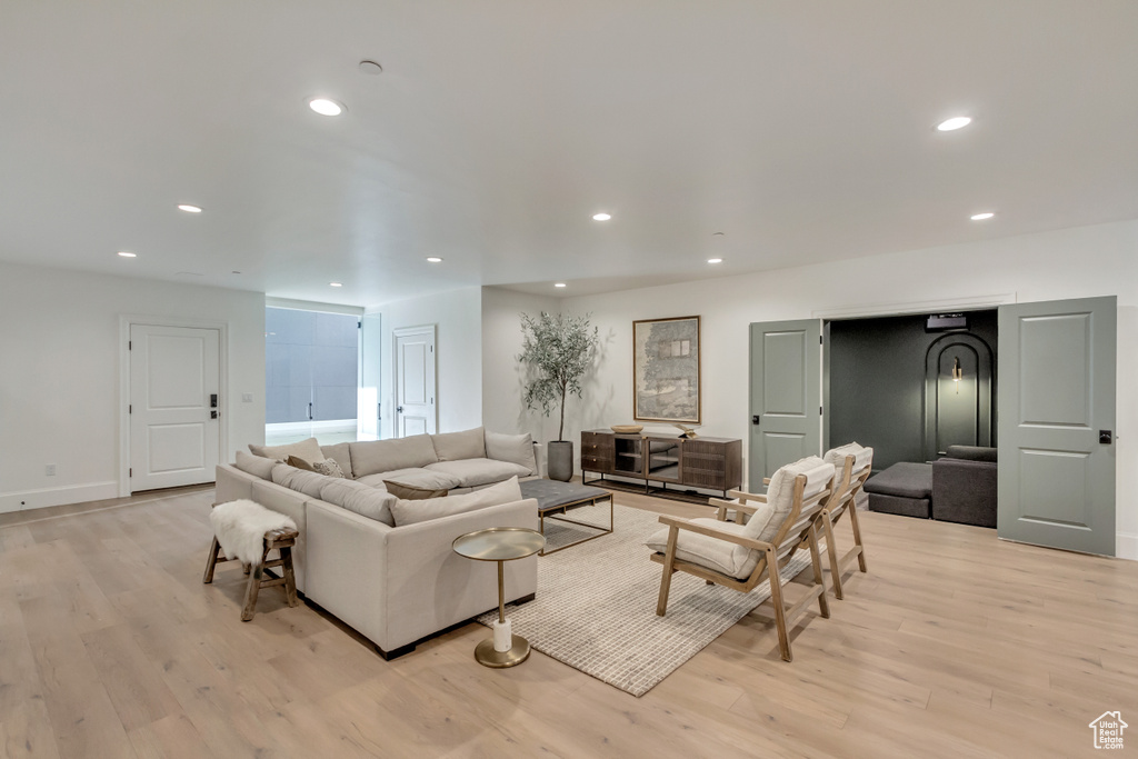 Living area featuring light wood-style flooring, recessed lighting, and baseboards