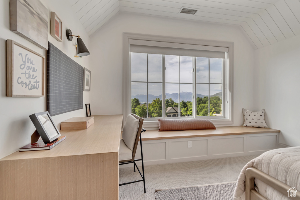 Bedroom with lofted ceiling, a mountain view, and carpet flooring