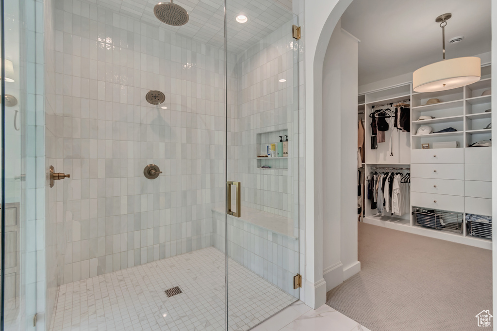 Full bath featuring a shower stall, a walk in closet, recessed lighting, and baseboards