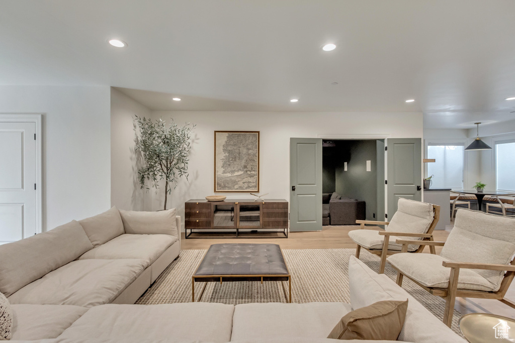 Living area featuring light wood-type flooring and recessed lighting
