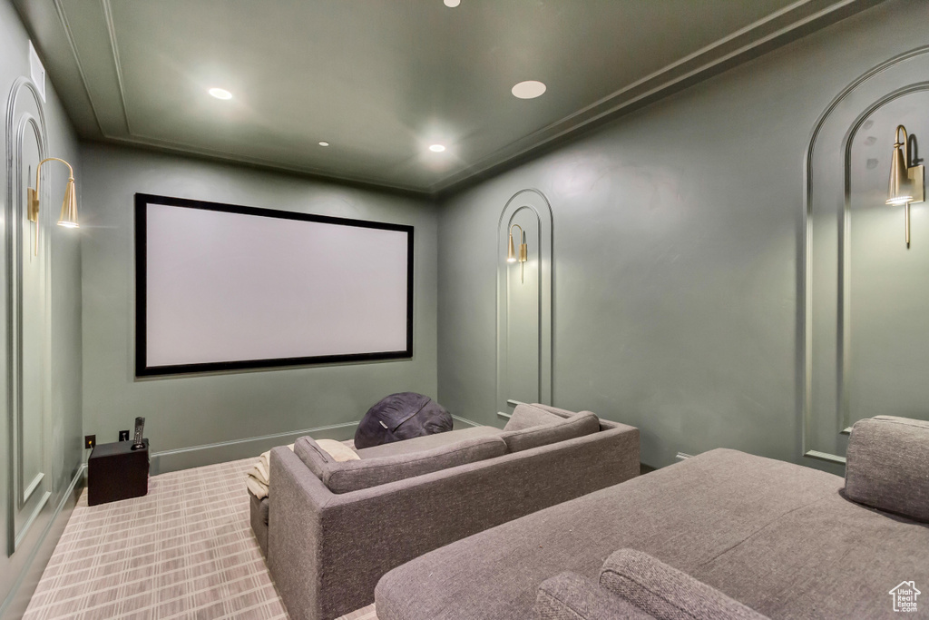 Carpeted cinema room with recessed lighting
