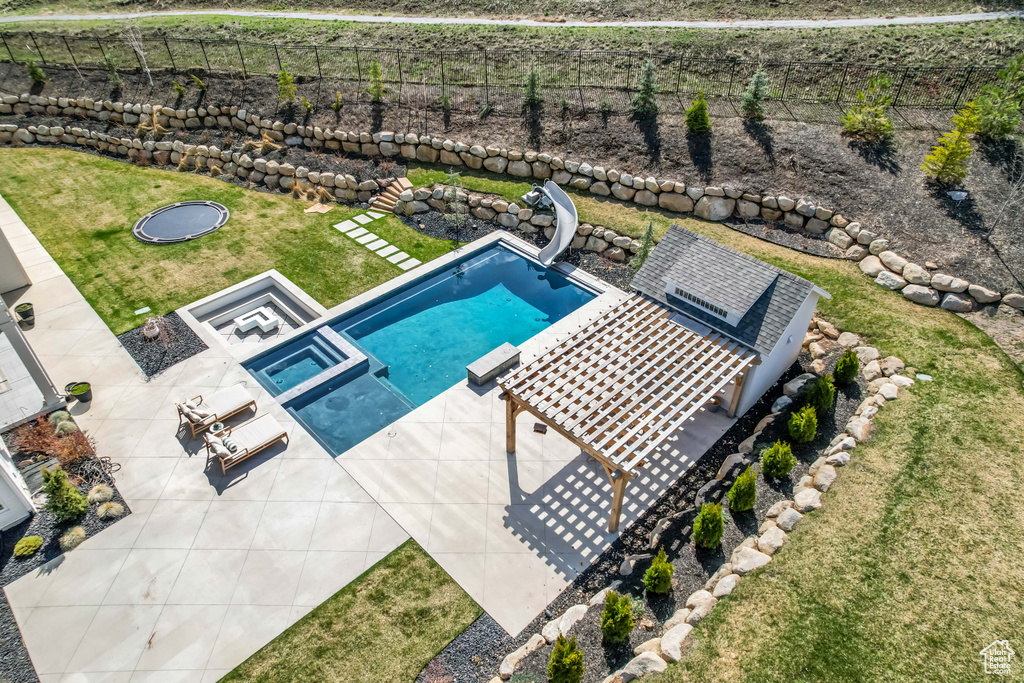 Swimming pool featuring a water slide and a patio