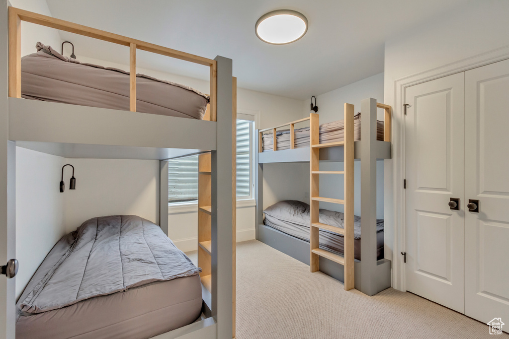 Carpeted bedroom with a closet