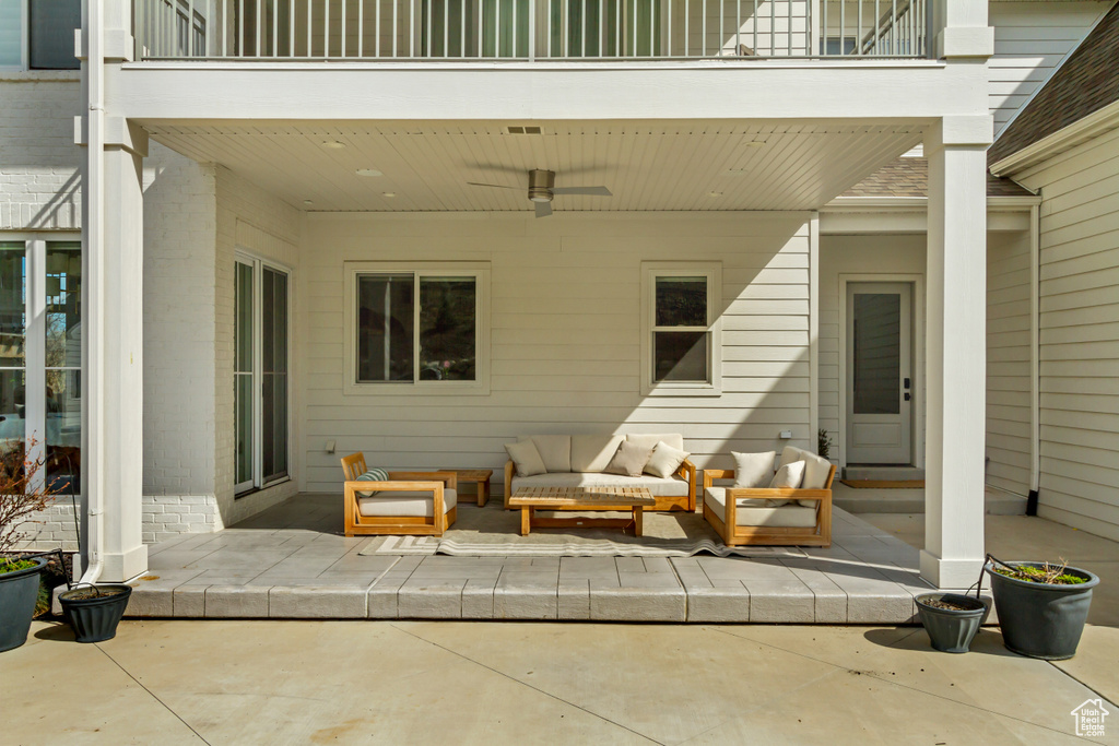 View of patio featuring an outdoor living space, a balcony, and a ceiling fan