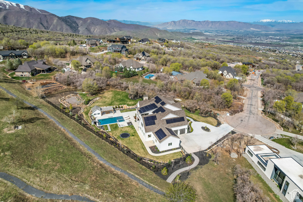 Aerial view of property\'s location with nearby suburban area, a mountain backdrop, and a pool
