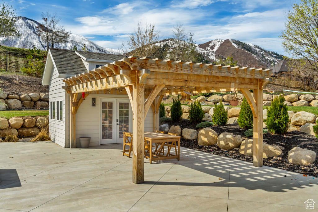 View of patio / terrace featuring french doors, a mountain view, and a pergola