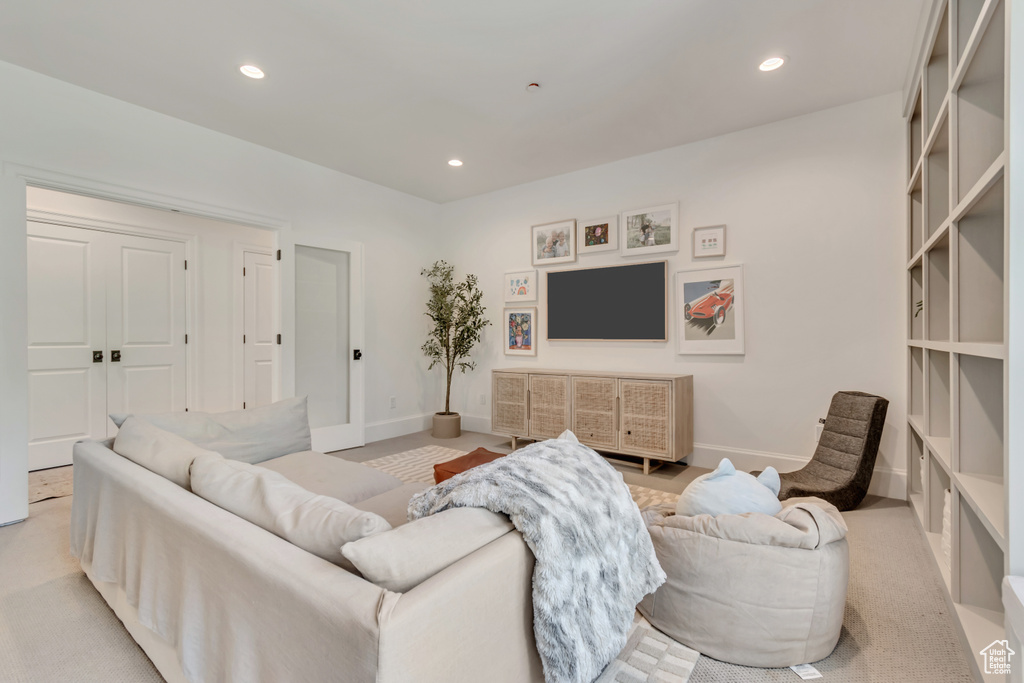 Living room featuring recessed lighting, baseboards, and light colored carpet