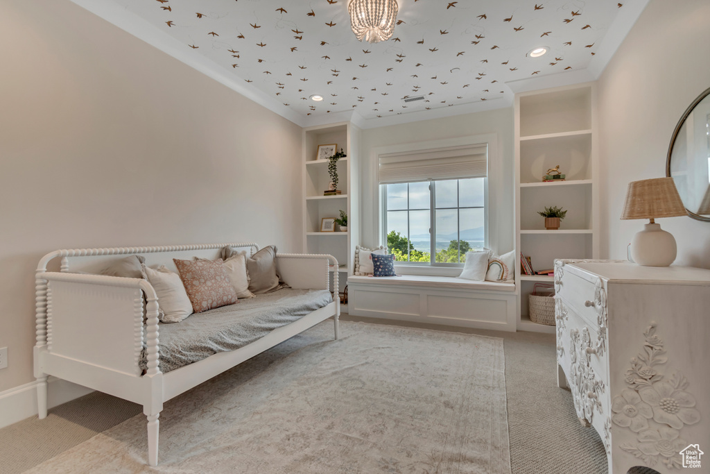 Bedroom featuring light carpet, ornamental molding, and a chandelier