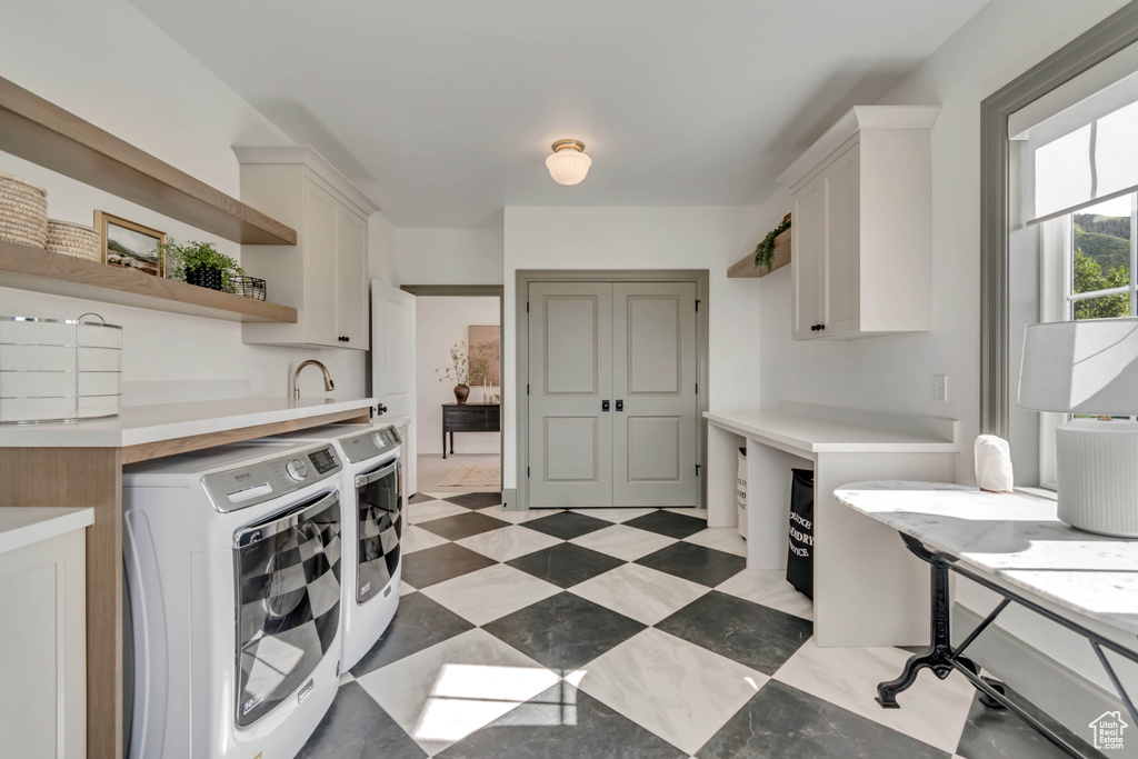 Kitchen featuring washer and clothes dryer, light countertops, white cabinets, and open shelves