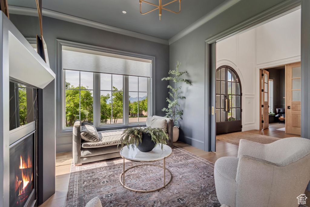 Living room featuring wood finished floors and ornamental molding
