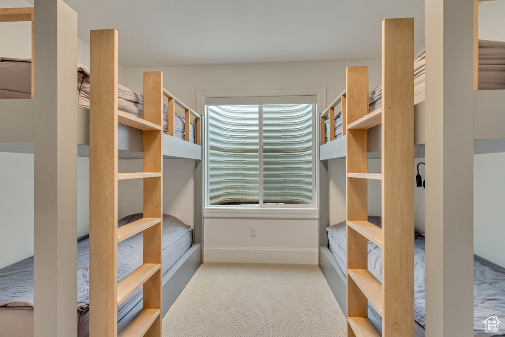 Walk in closet with carpet flooring