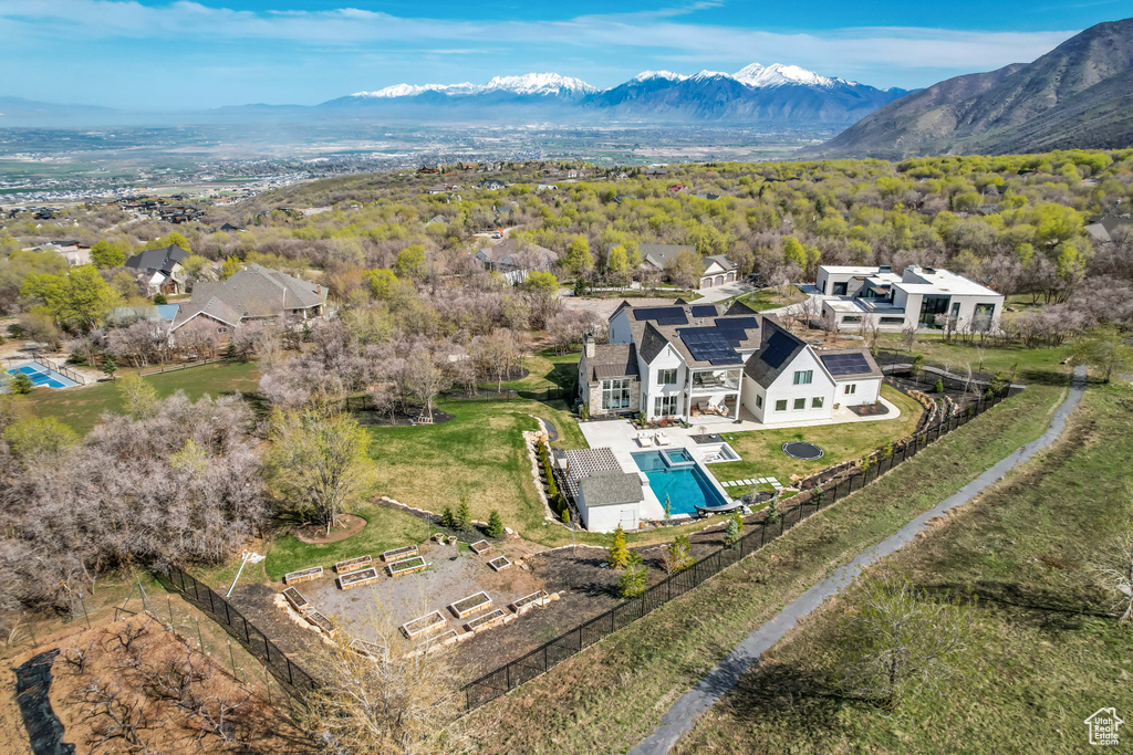 View from above of property featuring a pool area and a mountainous background