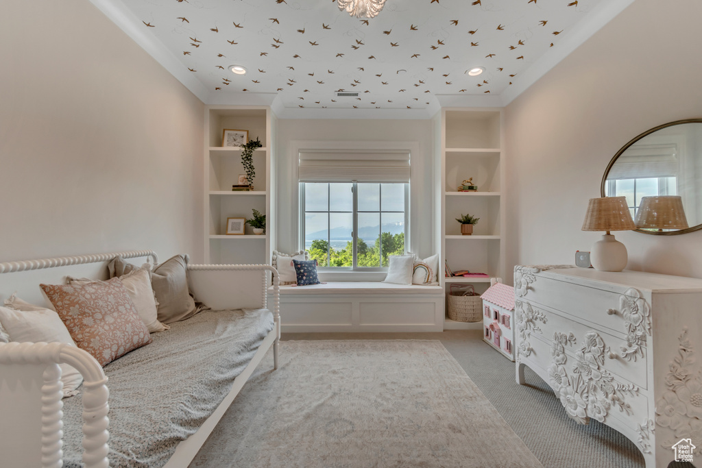 Sitting room with ornamental molding and light carpet